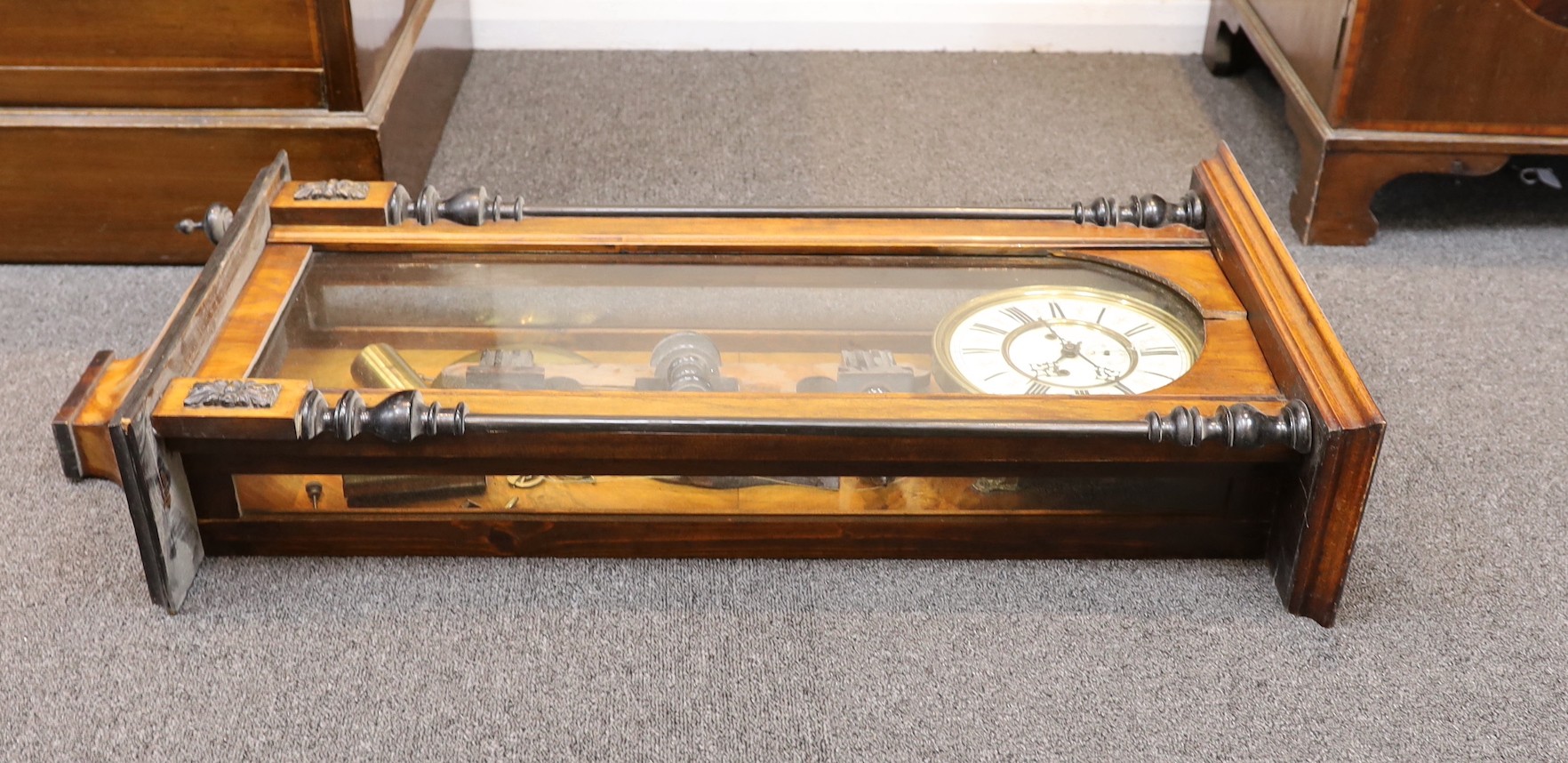 A late 19th century part ebonized walnut Vienna type wall clock, circular dial with subsidiary seconds, height 92 cms